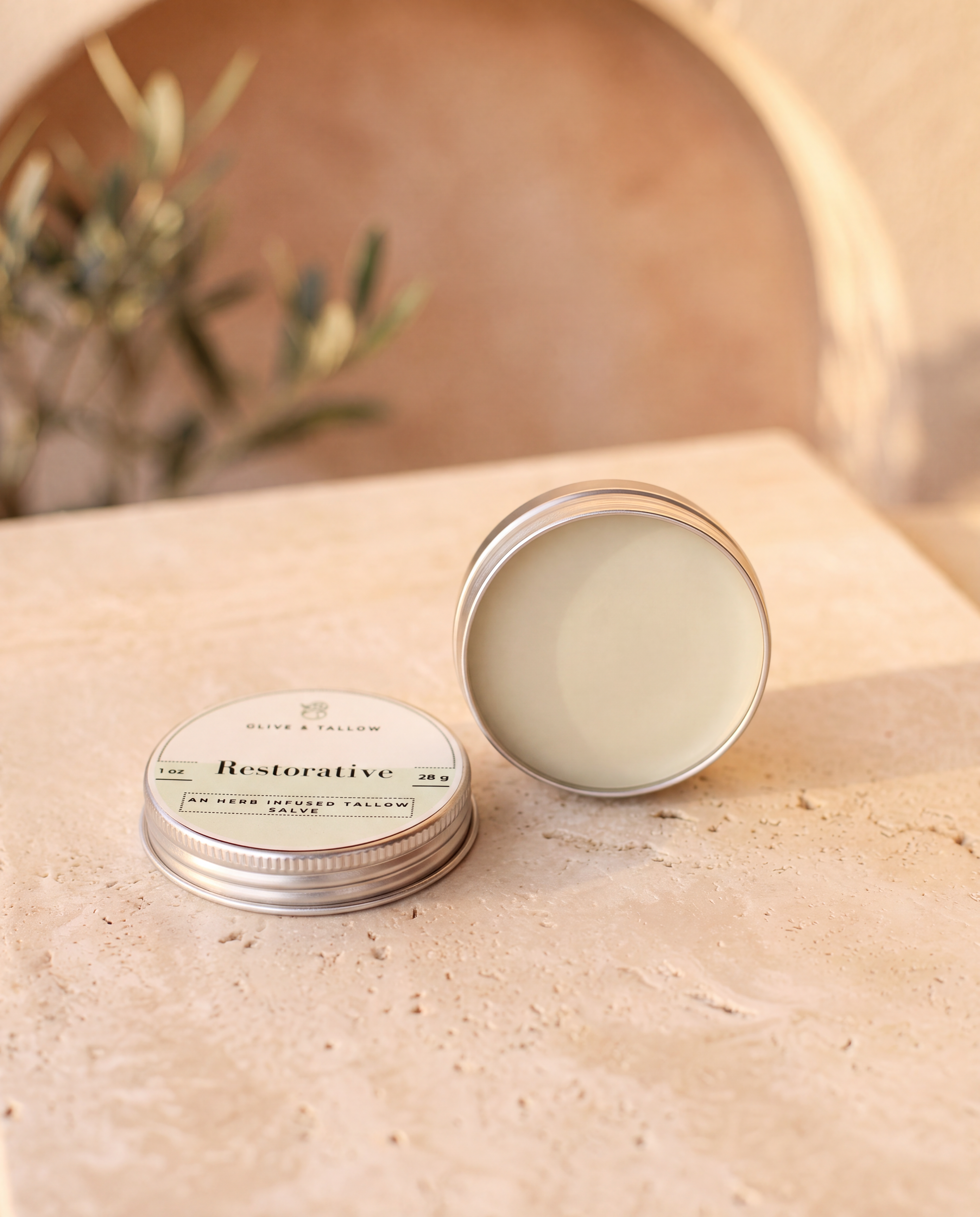 Herbal grass-fed tallow salve in an open tin
