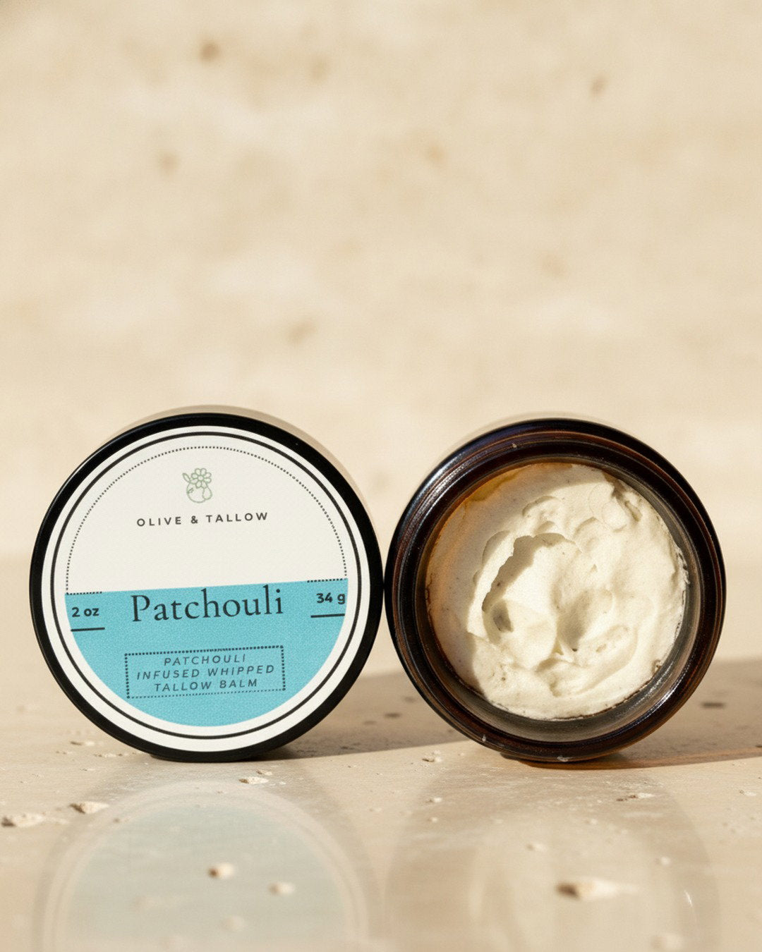 Open jar of earthy patchouli grass-fed tallow balm